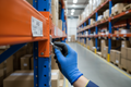 Gloved hand installing zinc-plated safety clip into teardrop connector on pallet rack beam