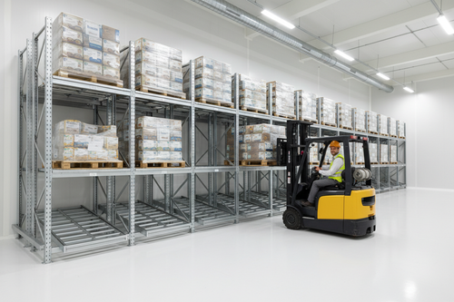 Push-Back racking in food-grade warehouse with forklift removing front pallet